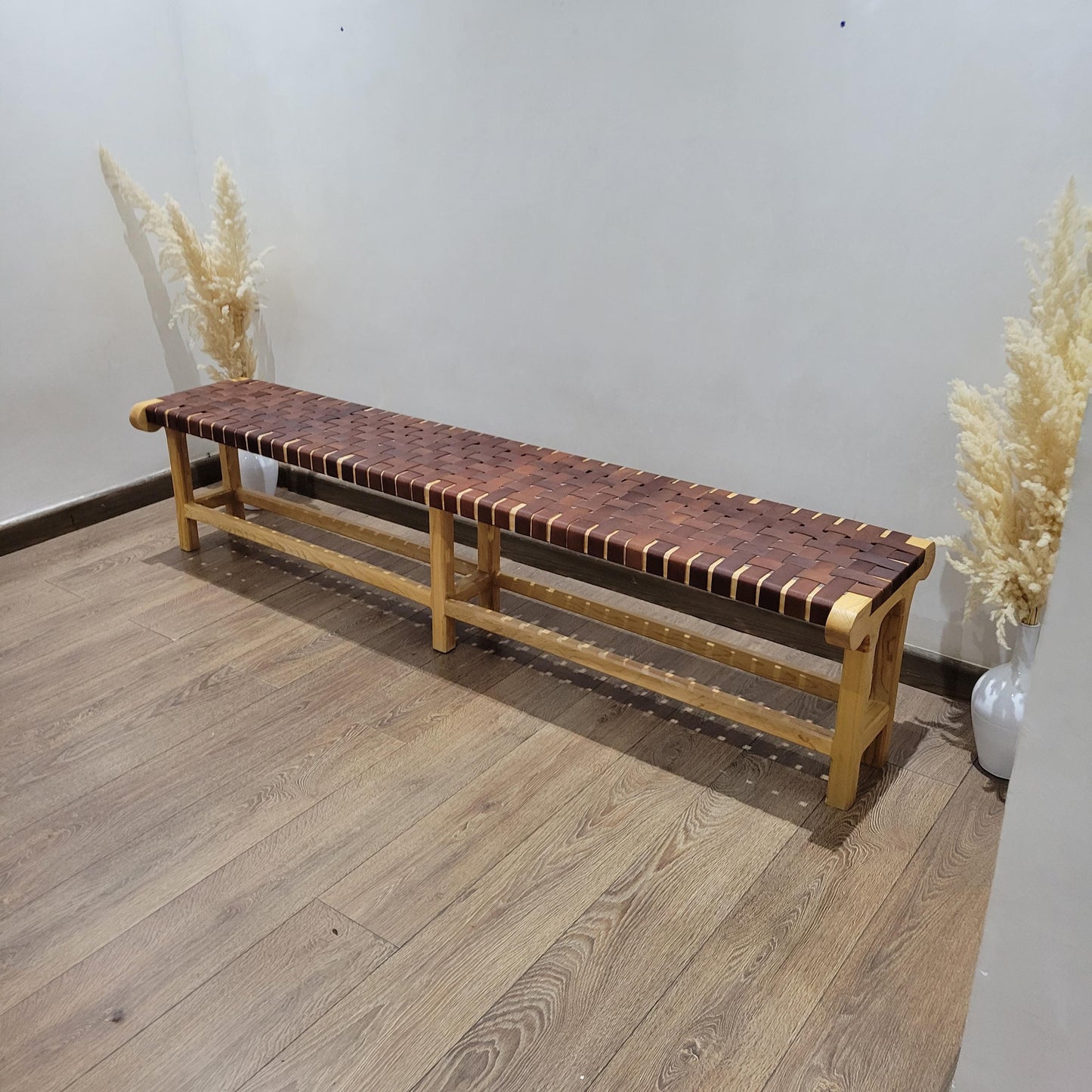 Woven Leather Bench — side view of artisan stitching