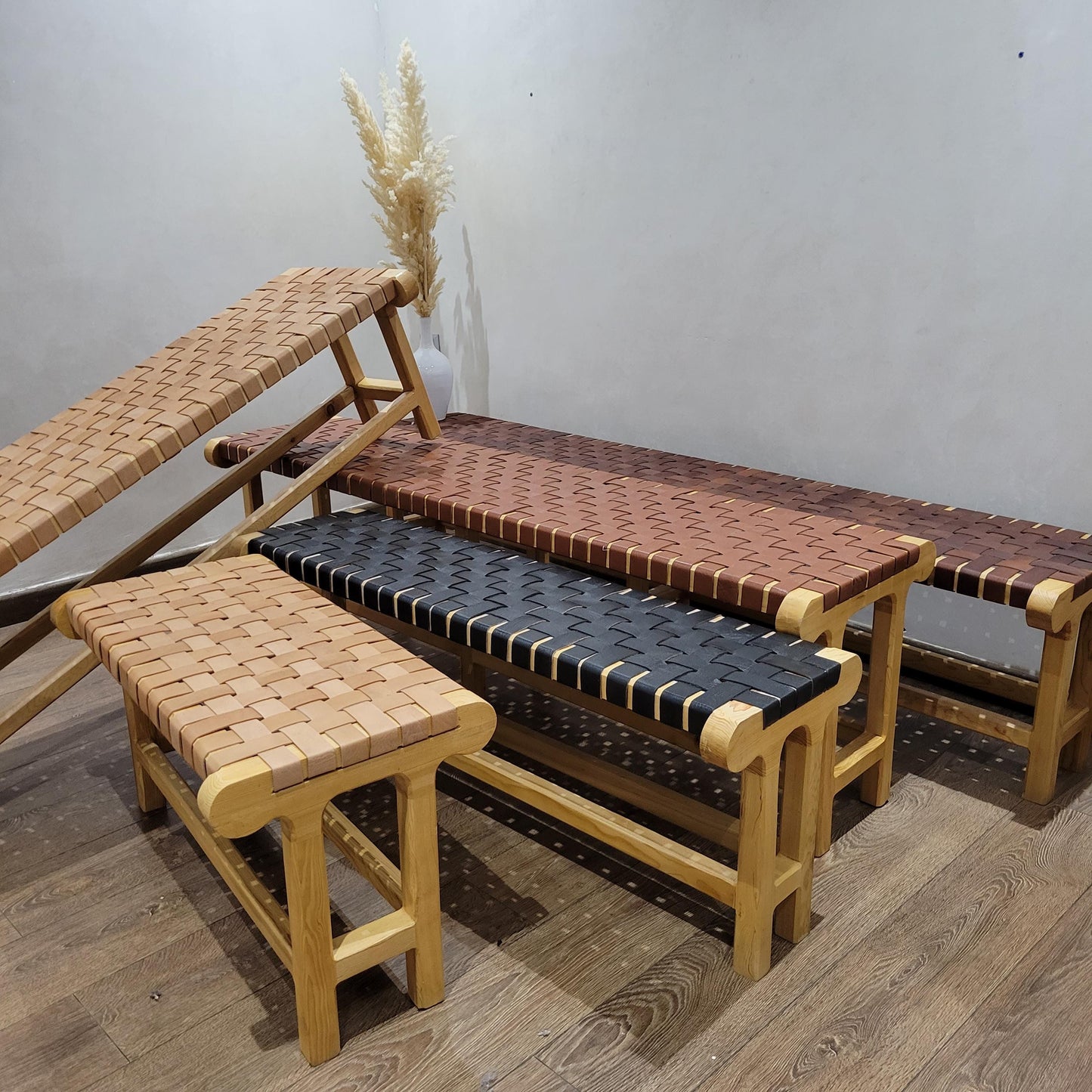 Woven Leather Bench — side view of artisan stitching