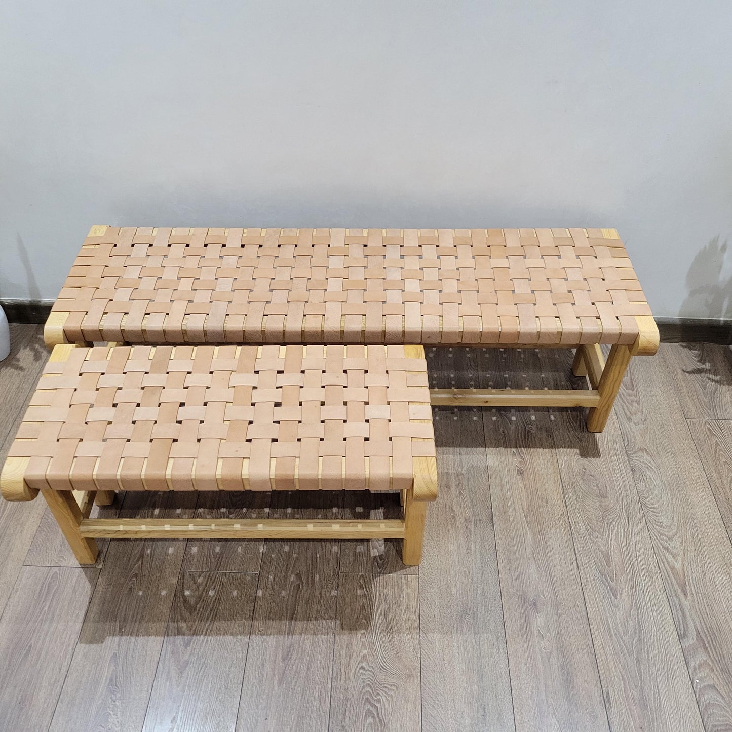 Woven Leather Bench — side view of artisan stitching