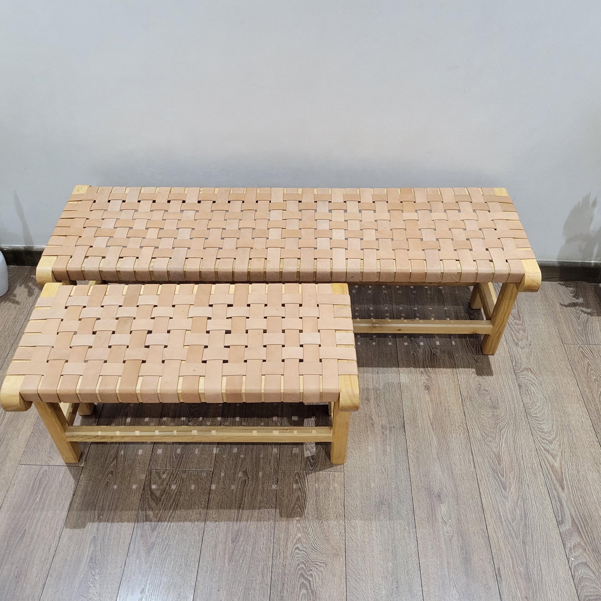Woven Leather Bench — side view of artisan stitching